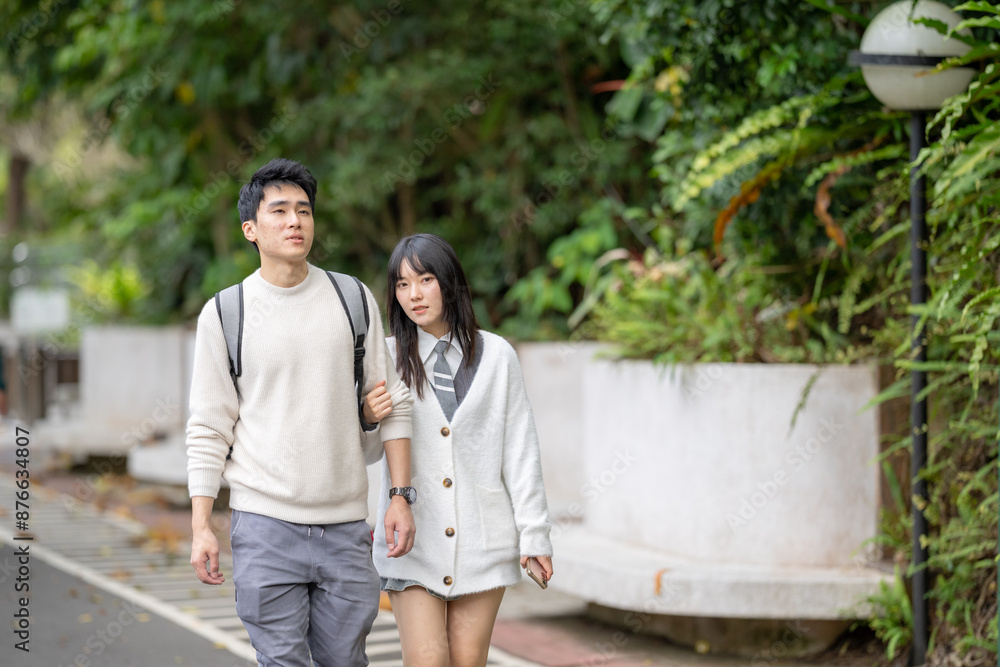 In March, a Taiwanese woman in her twenties and a Hong Kong man are walking in a lush botanical garden in Zhongzheng District, Taipei City, Taiwan. In March, a Taiwanese woman in her twenties and a Hong Kong man are walking in a lush botanical garden in Zhongzheng District, Taipei City, Taiwan.