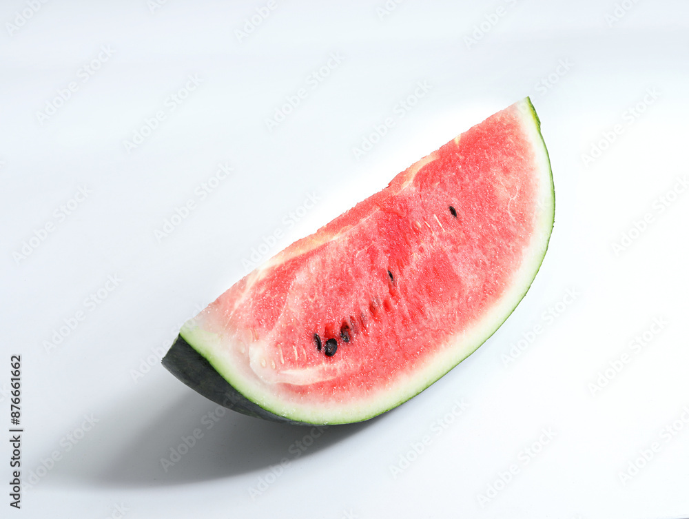 Watermelon, a fresh summer fruit, is cut open on a white table Watermelon, a fresh summer fruit, is cut open on a white table