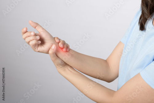 Wrist pain problem. Close up asian woman hold her pained wrist from work isolated on white background. office syndrome problem and healthcare concept.