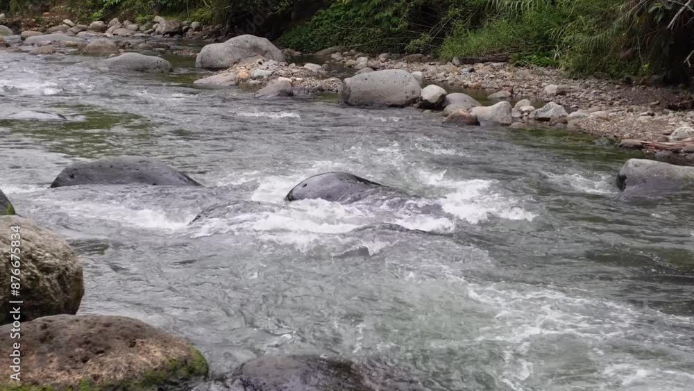 Flowing river water between rocks in the nature Flowing river water between rocks in the nature