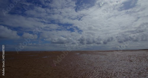 Panning shot of the beach at low tide,  at Theddlethorpe, Dunes, National Nature Reserve at Saltfleetby photo