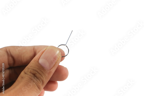 Hand Holding a SIM card ejector pin isolated on white background.