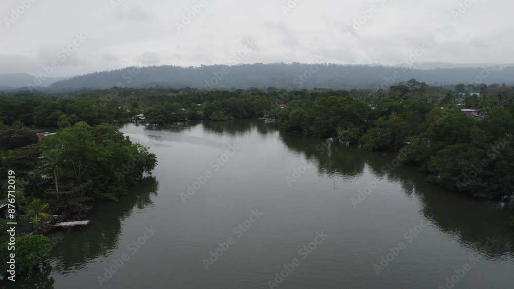 Calm river in lush greenery under cloudy skies in Almirante, Panama, aerial view Calm river in lush greenery under cloudy skies in Almirante, Panama, aerial view