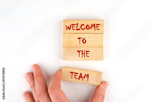 Welcome to the team. Text on wooden blocks laid out by hand on a white background