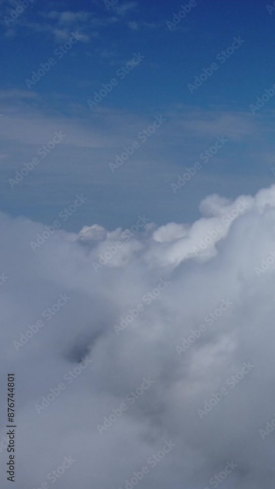 Aerial vertical view. High above thick fog, like beautiful ocean of clouds at sunrise. Sun is rising above endless sea of clouds until horizon. Amazing nature landscape. Climate and weather change Aerial vertical view. High above thick fog, like beautiful ocean of clouds at sunrise. Sun is rising above endless sea of clouds until horizon. Amazing nature landscape. Climate and weather change