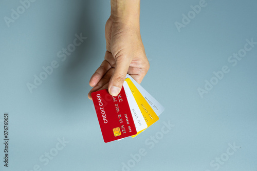 Man holding several credit cards and he is choosing a credit card to pay and spend Payment for goods via credit card. Finance and banking concept