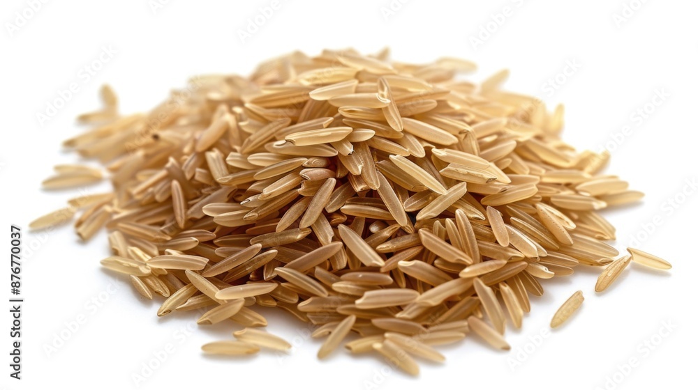 A pile of brown rice sits on a clean white surface, awaiting use or further processing A pile of brown rice sits on a clean white surface, awaiting use or further processing
