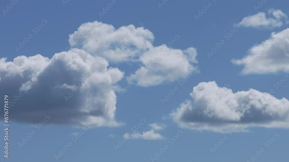 excellent filming in 70 mm with a drone of a cluster of clouds in a blue sky. They have the typical shape of white cotton and in some the lower part takes on dark tones. excellent filming in 70 mm with a drone of a cluster of clouds in a blue sky. They have the typical shape of white cotton and in some the lower part takes on dark tones.