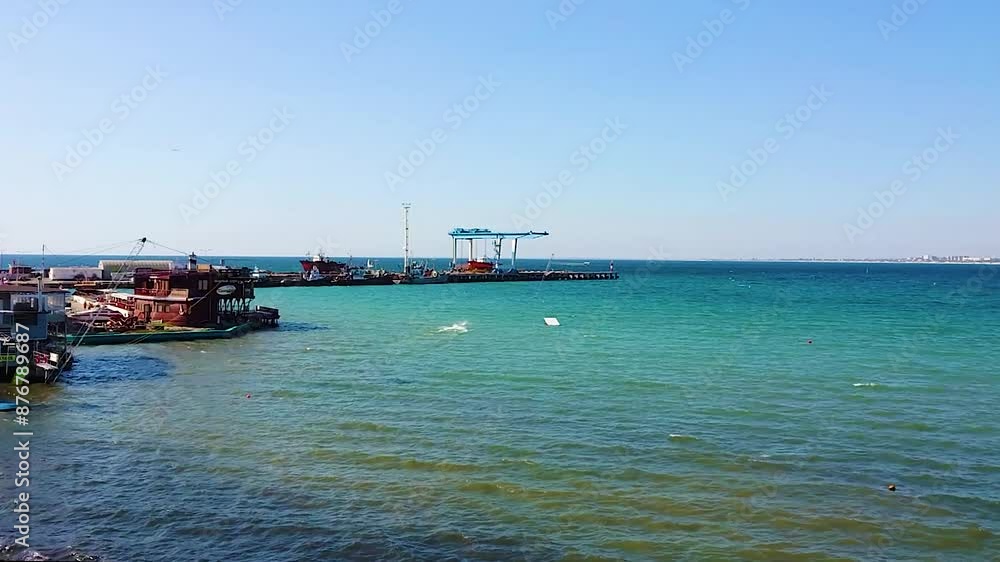 An old fishing pier, with shacks, overlooking the sea. An old fishing pier, with shacks, overlooking the sea.