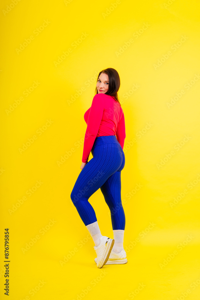 Active plus-size woman in sport top and leggings. Fitness, body positive, emotions, weight loss. Active plus-size woman in sport top and leggings. Fitness, body positive, emotions, weight loss.