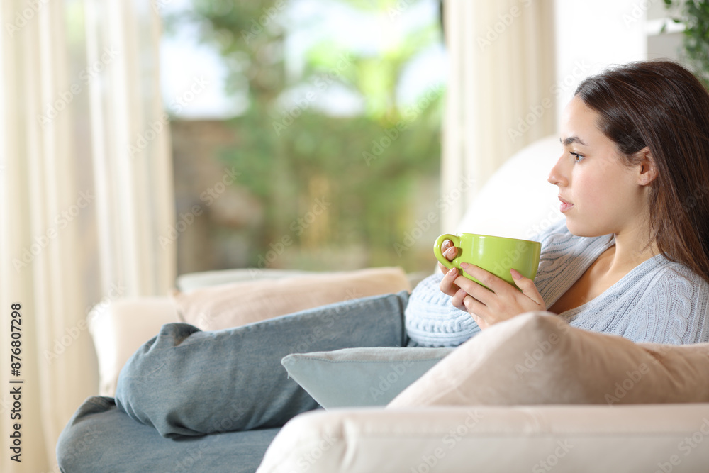Serious pensive woman drinking coffee at home Serious pensive woman drinking coffee at home