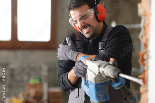 Принти на полотні Construction worker suffering arm ache using rotary hammer