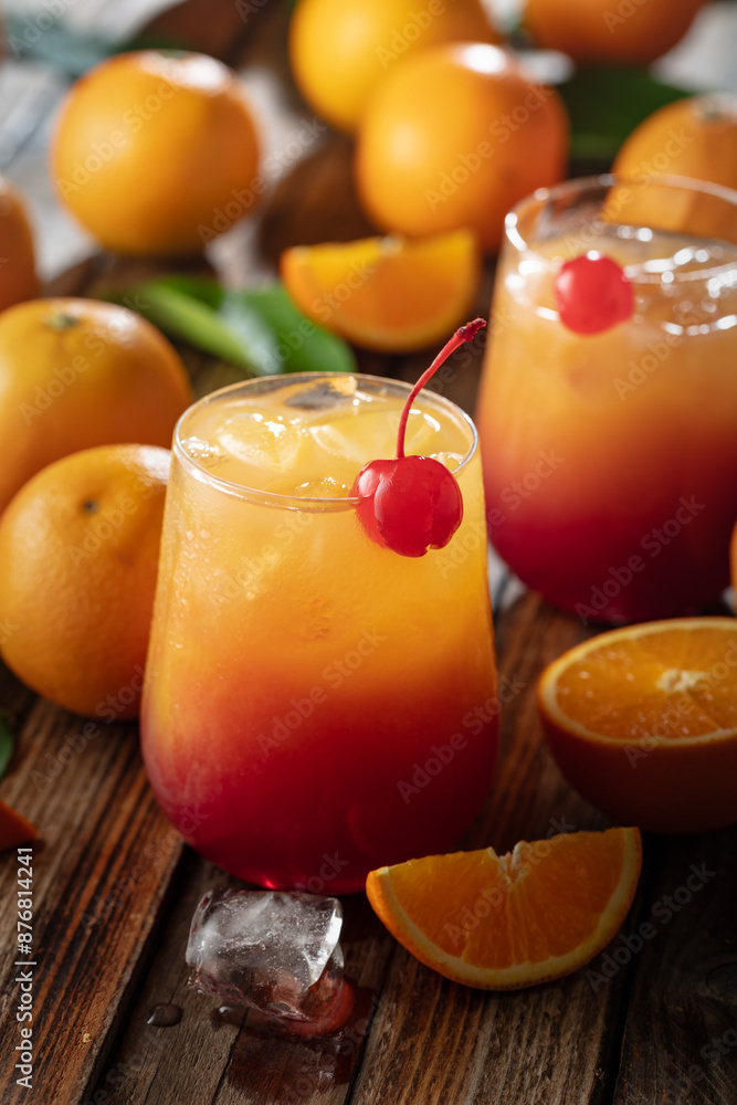 Classic tequila sunrise cocktail on an old wooden table.