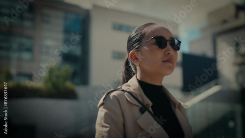 Young asian businesswoman communting to work outside modern office building. photo