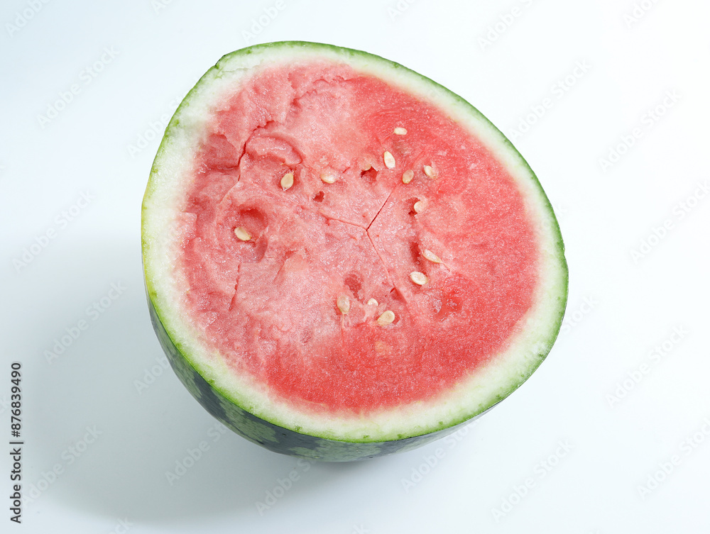 Watermelon, a fresh summer fruit, is cut open on a white table Watermelon, a fresh summer fruit, is cut open on a white table
