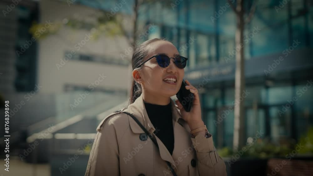 Young asian businesswoman communting to work outside modern office building. Young asian businesswoman communting to work outside modern office building.