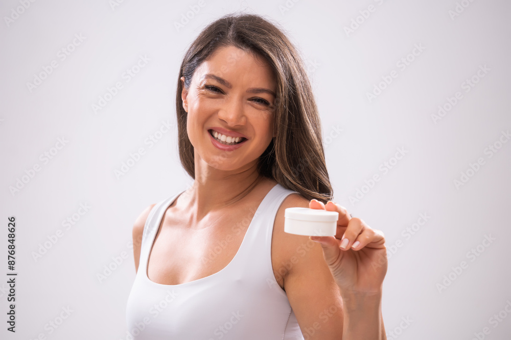 Portrait of adult woman who is holding skin cream. Portrait of adult woman who is holding skin cream.