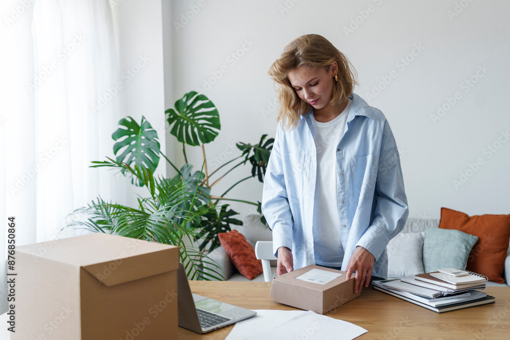 Businesswoman reading package details at home office Businesswoman reading package details at home office