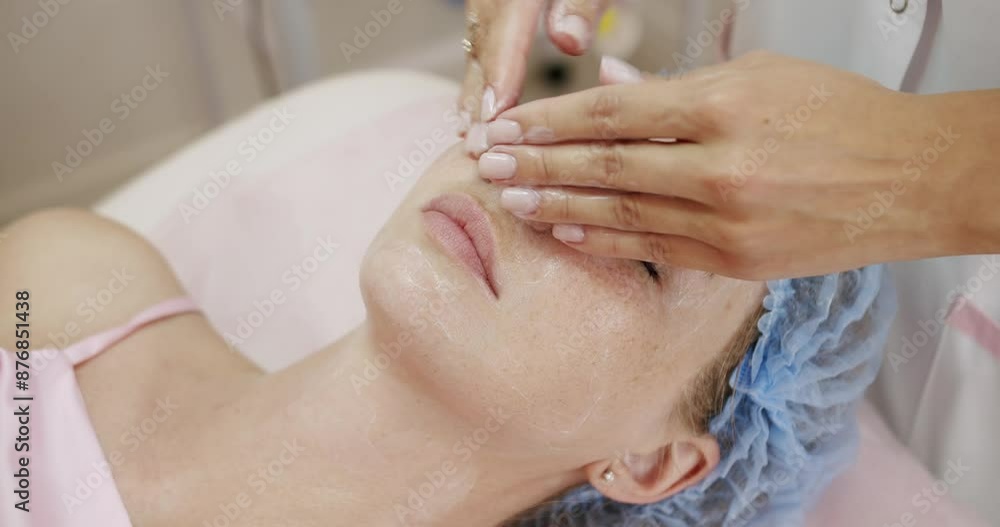 A peaceful scene of a woman enjoying a soothing facial treatment administered by a skilled esthetician in a serene spa setting. Woman Relaxing During a Professional Facial Treatment at Spa A peaceful scene of a woman enjoying a soothing facial treatment administered by a skilled esthetician in a serene spa setting. Woman Relaxing During a Professional Facial Treatment at Spa