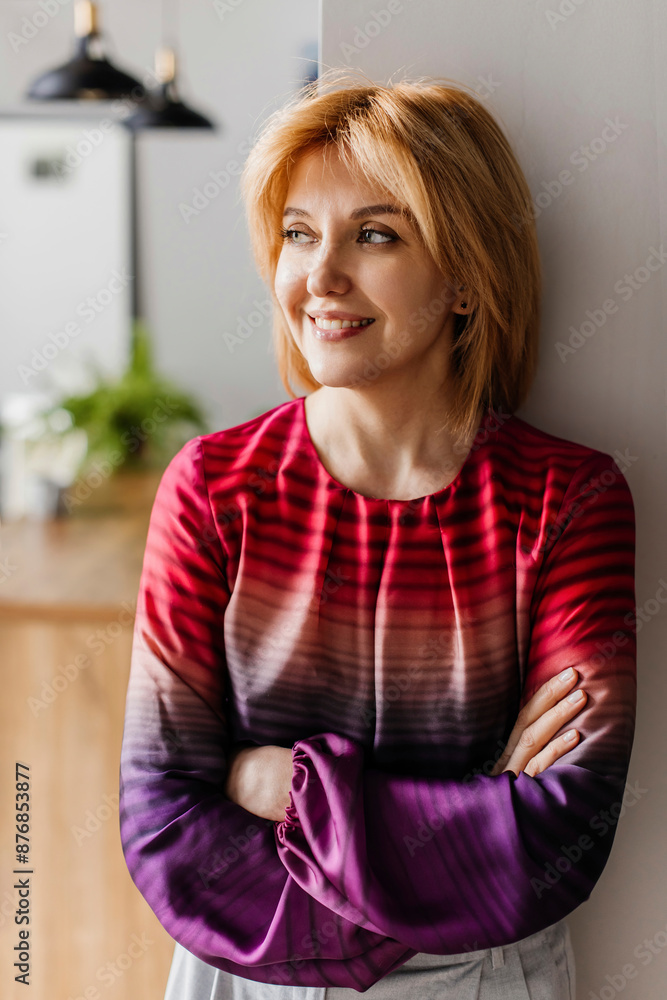 Smiling mature woman with arms crossed at home Smiling mature woman with arms crossed at home