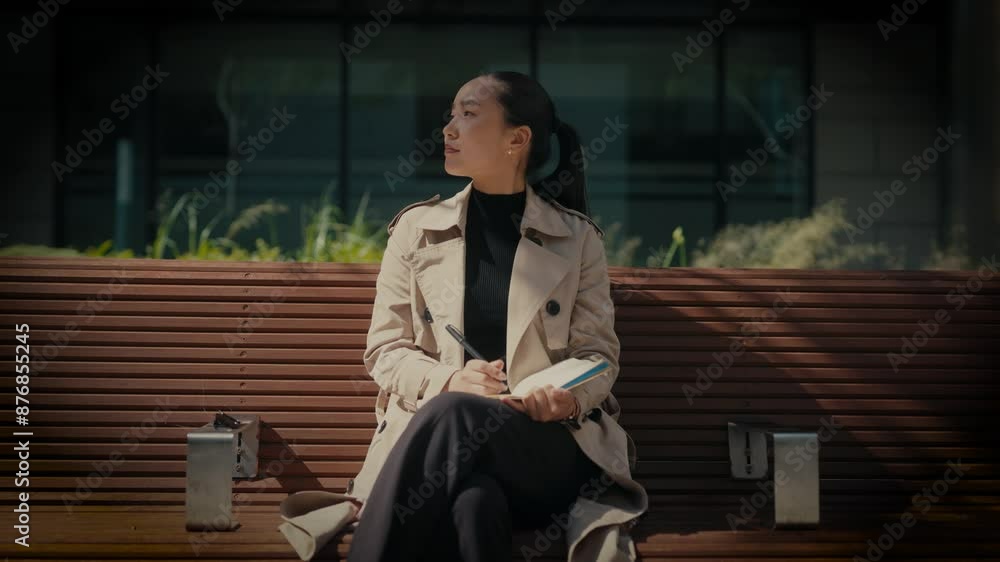 Young asian businesswoman working outside modern office building. Young asian businesswoman working outside modern office building.