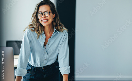 Happy business woman looking at the camera, expressing confidence in her professional capabilities