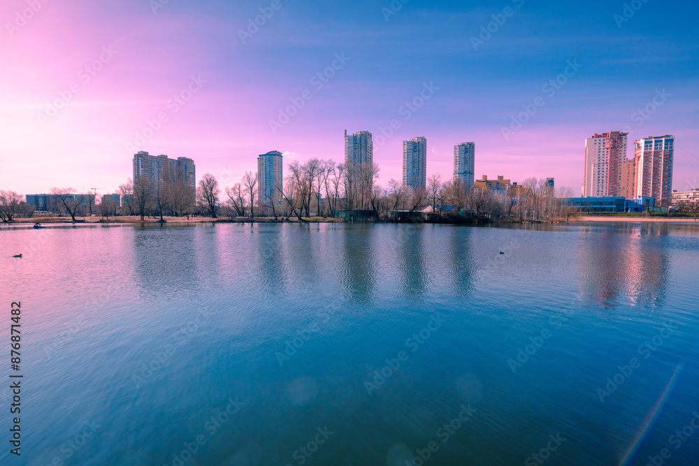 Naklejka premium Kyiv in the morning. Left bank of the Dnieper River. Beautiful reflection of buildings in the lake