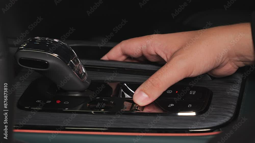 A man presses his hand on various buttons in a car A man presses his hand on various buttons in a car