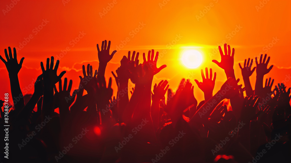 Fototapeta premium Crowd of Raised Hands at Sunset in Silhouette