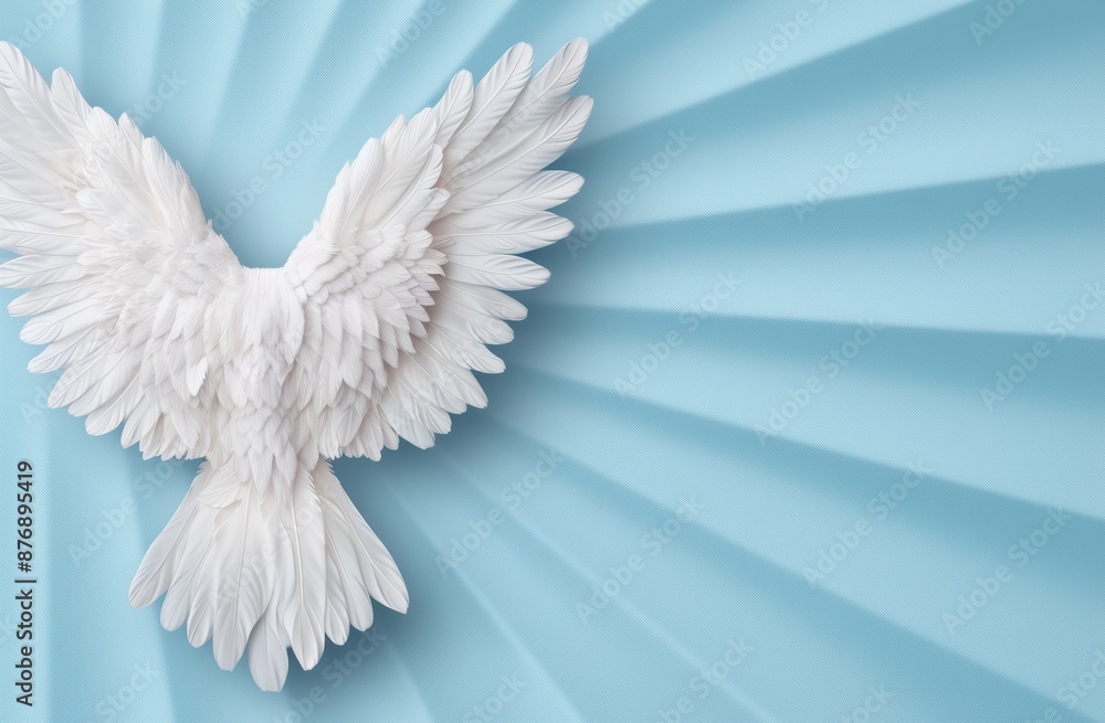 Fototapeta premium Angelic white feather wings against a blue sky