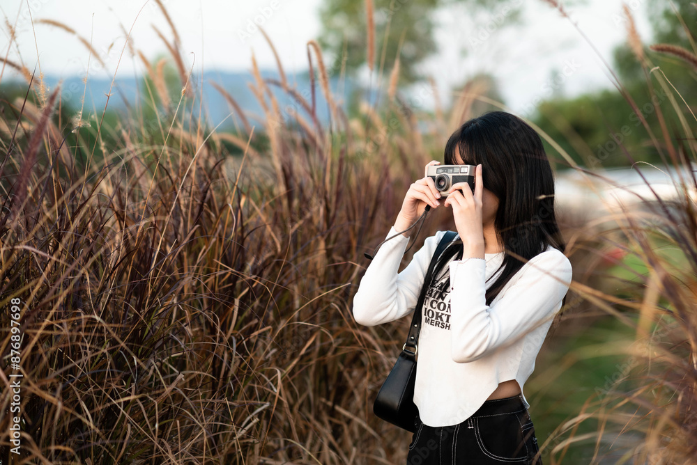 Φωτογραφία Portrait of amateur photographer young Asian woman traveler using vintage film camera