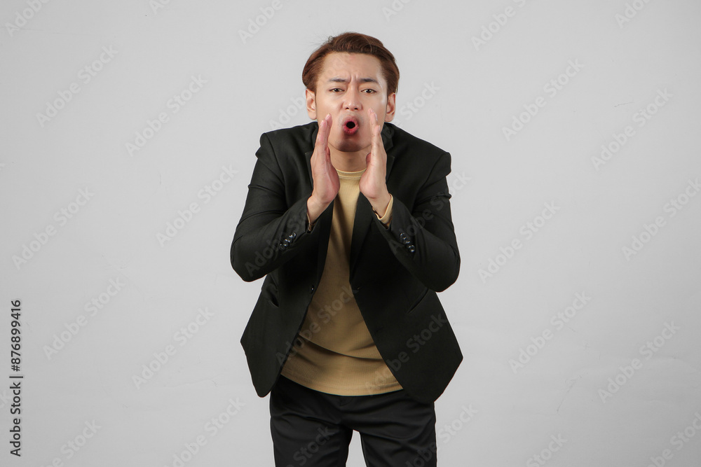 portrait of happy asian businessman wearing suit shouting with cupping hand on isolated background portrait of happy asian businessman wearing suit shouting with cupping hand on isolated background