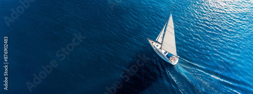 Sailing yacht in clear blue sea, aerial view, minimalist seascape, luxury vacation concept