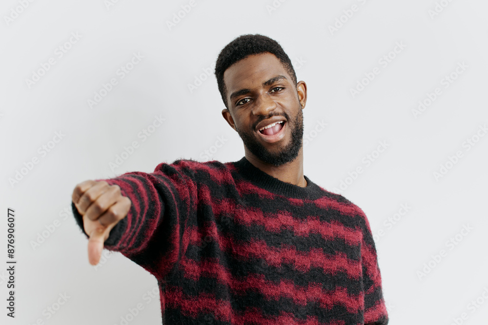 Fototapeta premium Confident man in red and black sweater pointing directly at camera on white background
