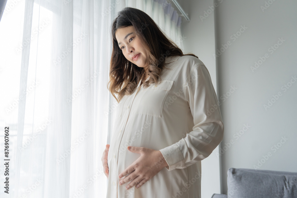 Pregnant asian woman holds hands on belly touching her baby caring about her health Beautiful happy pregnant woman tender mood photo of pregnancy Pregnant asian woman holds hands on belly touching her baby caring about her health Beautiful happy pregnant woman tender mood photo of pregnancy