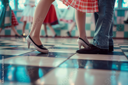 dancing feet of couple on checkered floor at a sock hop photo