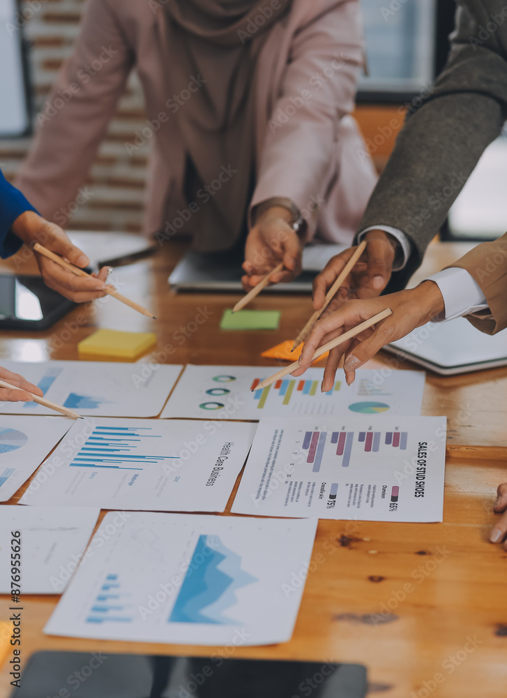 © ARMMY PICCA - Business professionals. Group of young confident business people analyzing data using computer while spending time in the office