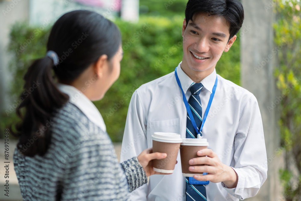 Business team walking and talking on street in city Outside Office with ,young couple discussing and drinking coffee together, partners, teamwork. Business team walking and talking on street in city Outside Office with ,young couple discussing and drinking coffee together, partners, teamwork.