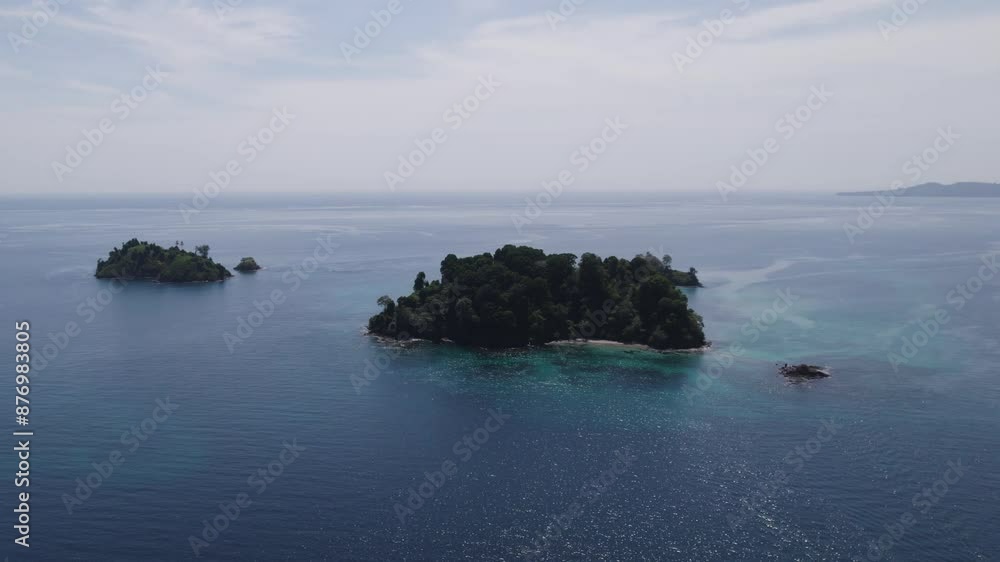 Two lush islands surrounded by clear blue ocean on a sunny day, aerial view Two lush islands surrounded by clear blue ocean on a sunny day, aerial view
