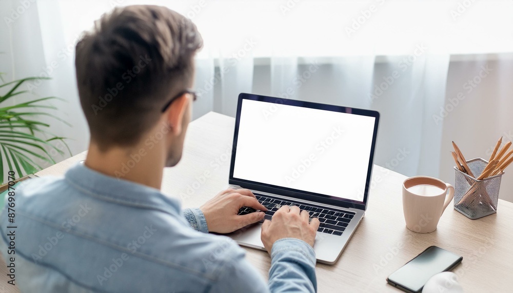 Back view of business man freelancer sitting in home office at table Back view of business man freelancer sitting in home office at table