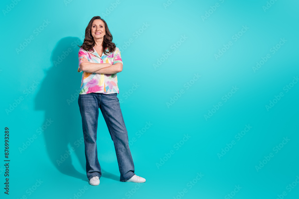 Full length photo of lovely pensioner lady crossed hands confident dressed stylish colorful garment isolated on cyan color background Full length photo of lovely pensioner lady crossed hands confident dressed stylish colorful garment isolated on cyan color background
