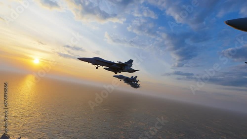 Fighter jet flies over aircraft carrier sailing over sea