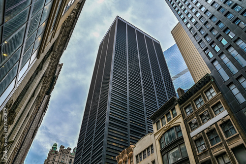 Cityscape of America most famous New York City - Wall Street view with clouds