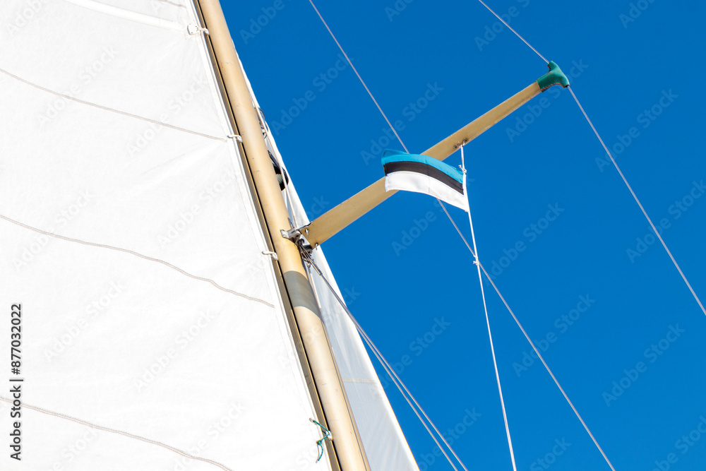 Fototapeta premium Estonian flag on yacht on a shroud under spreader. White and blue. Sailing rules.