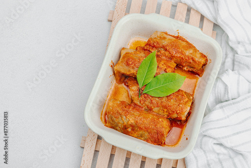 Cabbage rolls stuffed with rice and meat stewed in tomato sauce. Traditional dish, ready-to-eat food photo