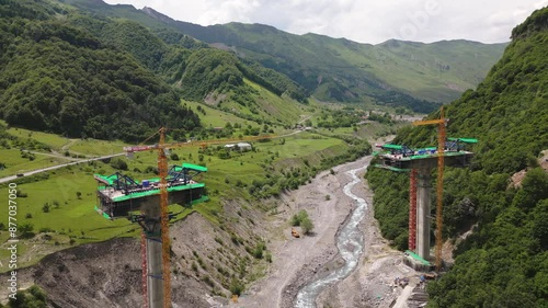 Kazbegi, Georgia - 7th july, 2024: aerial view cranes and bridge foundation pillars on construction site of new highway road project built by chinese builders.Avalanche bypass tunnel.Tbillisi - Lars photo