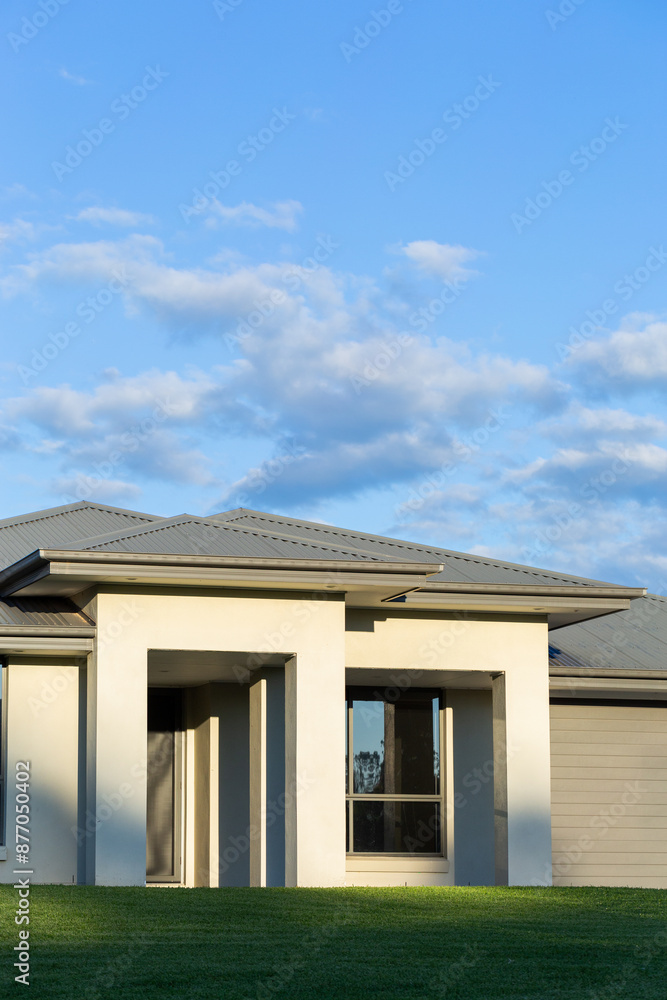 last daylight on front of house with tin roof of home and neat lawn last daylight on front of house with tin roof of home and neat lawn