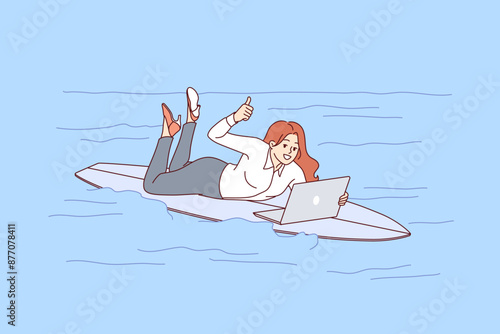 Woman freelancer rides surfboard on sea and works with laptop, showing thumbs up. Busy girl freelancer in casual clothes jobs during vacation due to lack of time management skills.