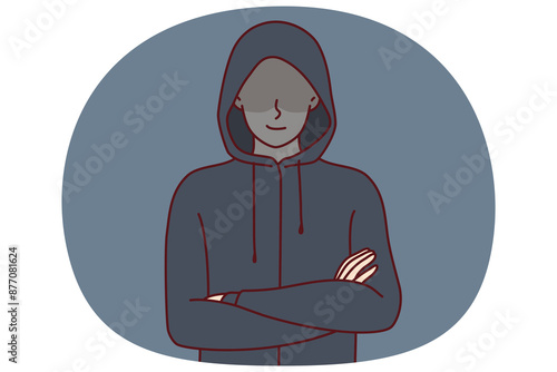 Anonymous man stands with arms crossed and hiding eyes behind hood for concept of secret surveillance or banditry. Anonymous guy hiding face wanting to remain incognito planning illegal activities