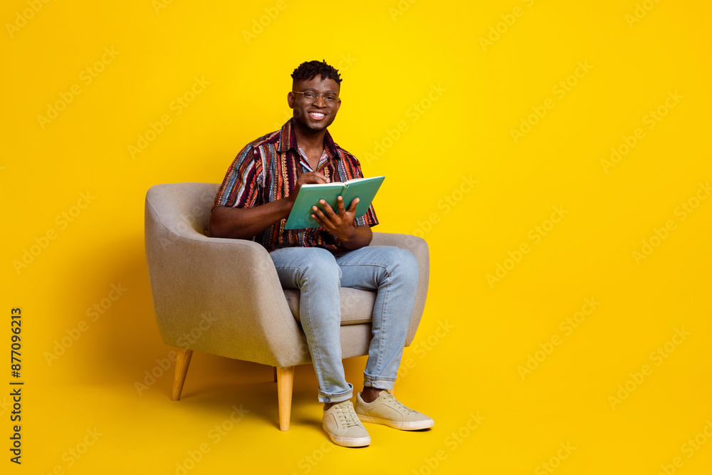 Full body portrait of nice young man sit chair laptop notebook wear shirt isolated on yellow color background Full body portrait of nice young man sit chair laptop notebook wear shirt isolated on yellow color background